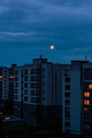High rise night view and bright moon in the skyの素材
