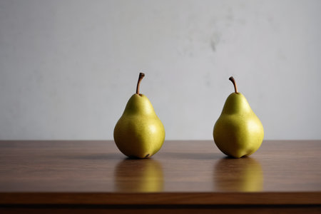 Two yellow green pears on a wooden tableの素材