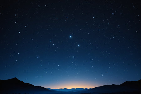 View of the mountains under the stars in the night skyの素材