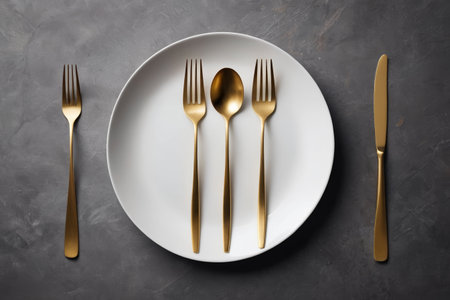 White dinner plate with gold cutleryの素材