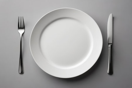 White dinner plate and knife and fork arrangement sceneの素材