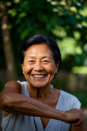A happy elderly woman smiling outdoorsの素材
