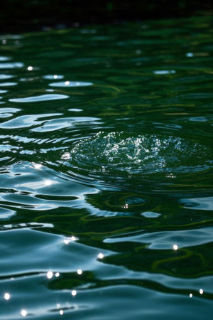 Close up of water droplets falling on the water surfaceの素材