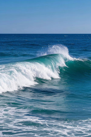 White waves surging in the blue oceanの素材