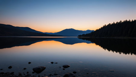 Tranquil lake and forest landscape at duskの素材