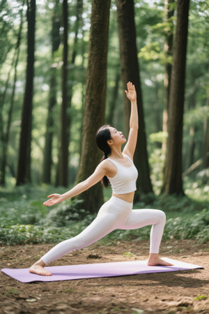 Woman doing yoga in outdoor forestの素材