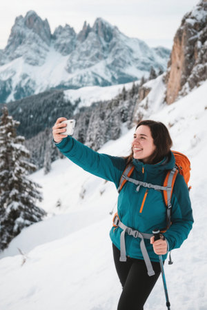 Selfie scene of a woman hiking in the snow capped mountainsの素材
