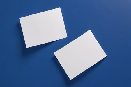 Two blank cards on a blue backgroundの素材