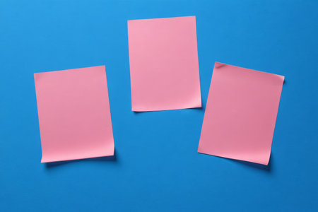 Pink sticky notes on a blue backgroundの素材