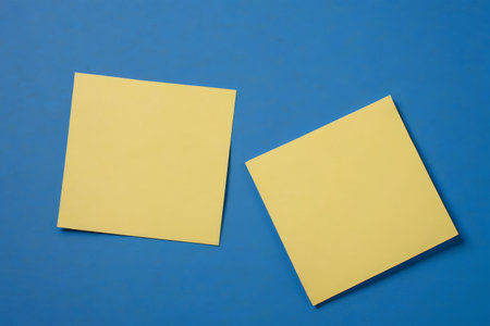 Two yellow sticky notes on a blue backgroundの素材