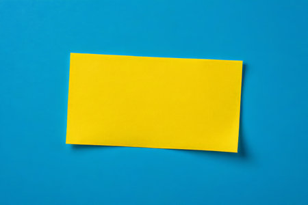 Yellow blank paper on blue backgroundの素材
