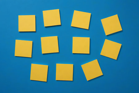 Yellow sticky note on blue backgroundの素材