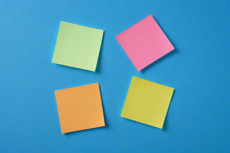 Colored sticky notes on a blue backgroundの素材