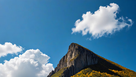 Mountain landscape under blue sky and white cloudsの素材