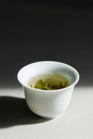 Green tea in a white teacupの素材
