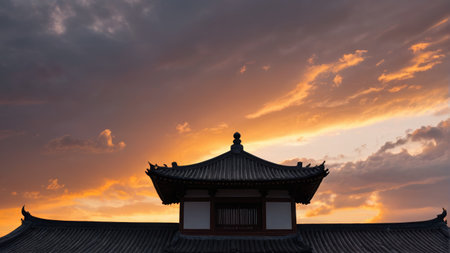 The roof of an ancient Chinese building at sunsetの素材