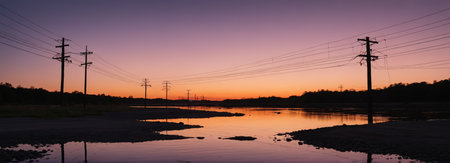 Telephone poles by the water and the sky at duskの素材