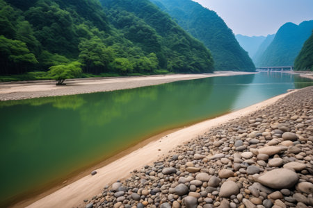 Riverbank scenery with green mountains and green waterの素材