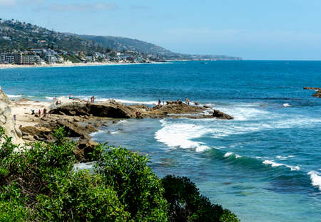 Tide pools, sea waves and rocks, with rocky beach from high up on a bluff at Crescent Bay Point Park in Laguna Beach, CA.の写真素材