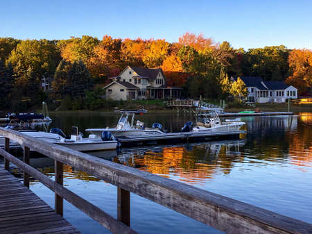 Portsmouth, NH / USA - Oct 16, 2018: Beautiful autumn landscape of docked boats, waterfront homes,...