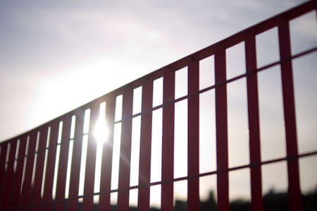 Sun beaming through red railingsの写真素材