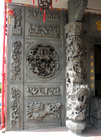 Chinese temple Penang 2, carved stone pillar, and door of a Chinese temple in Penang, Malaysiaの写真素材