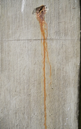 rust on concrete, a rust stain dripping down a concrete surface の写真素材