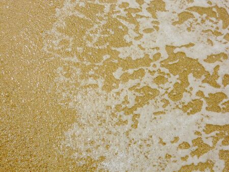 sand and sea 3, yellow sand and delicate sea foam on a tropical beachの写真素材