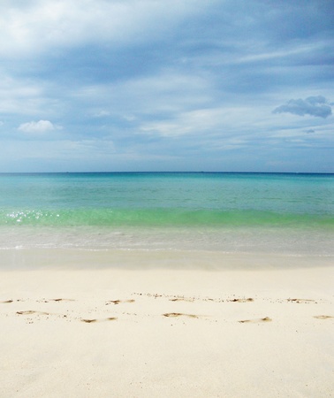 tropical beach with footprints,  Bang Tao Beach, Phuket, Thailand, Asia , beautiful tropical beach with gentle ripples in turquoise waters and a line of footprints in the sand の写真素材