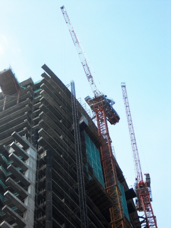 Skyscraper construction 2, cranes working on the contruction of a modern skyscraper, Kuala Lumpur, Malaysia, Asiaの写真素材