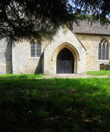Ancient church doorway 1, outside view of a small church door, Eastleach, Cotswolds, UKの写真素材