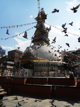 Nepalese temple, pigeons flying over part fo a temple in Kathmanduの写真素材