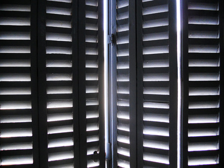 sun through shutters, sunlight through wooden window shuttersの写真素材