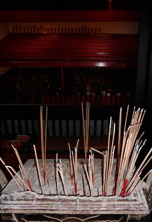 red Chinese incense sticks burning outside a Chinese temple, Asiaの写真素材