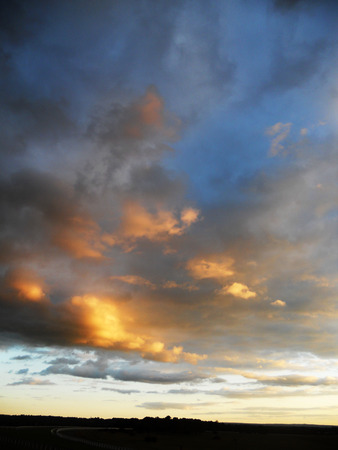 a delicate sunset in blues and golds, with small light cloudsの写真素材