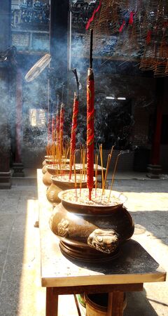 incense, big and small, in pots in a Chinese templeの写真素材
