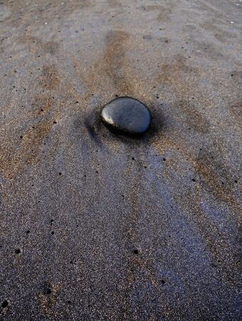 sand with glossy black pebble