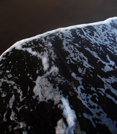 Black sand and surfの写真素材