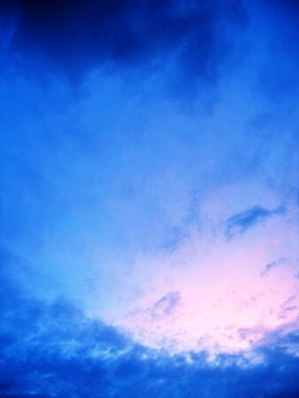 Clouds with beautiful delicate colors in evening lightの写真素材