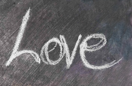 love chalkboard : the word "love" written in chalk, white on black.の写真素材