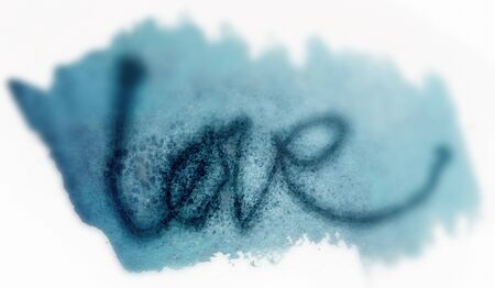 Love painted, the word love hand-painted, artistic word love, dark lettering on watercolor area with blur vignette on white background.の写真素材