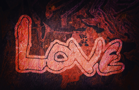 Love painted, the word love hand-painted with outset border, artistic word love, pale street-style lettering on organic texture, red and dark with dark vignette.の写真素材