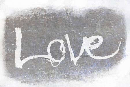 love painted, the word love hand-painted, artistic word love, pale brush lettering on gray grunge texture on pale background.の写真素材