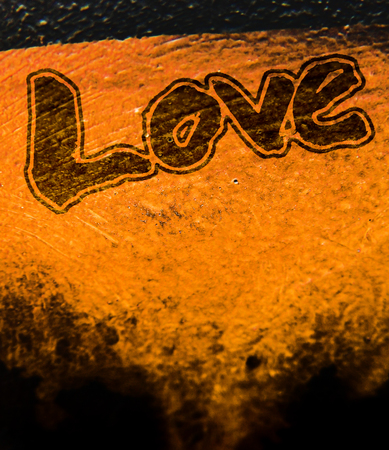 love painted, the word love hand-painted, artistic word love, outlined brush lettering on orange texture.の写真素材