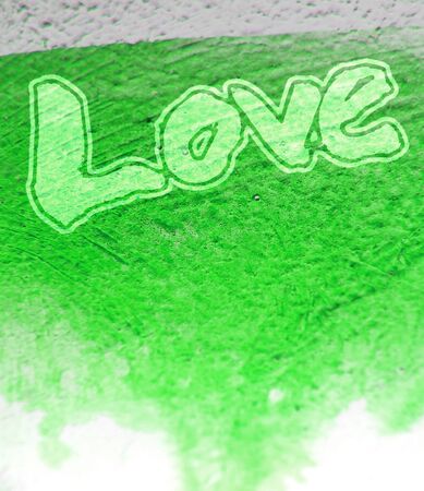 love painted, the word love hand-painted, artistic word love, pale street-style brush-painted lettering on green painted texture.の写真素材