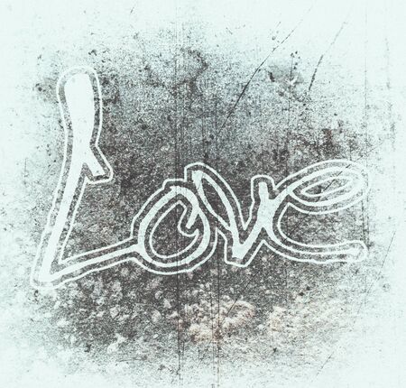 Love painted, the word love hand-painted, artistic word love, pale brush lettering outlined on grunge texture with pale vignette.の写真素材