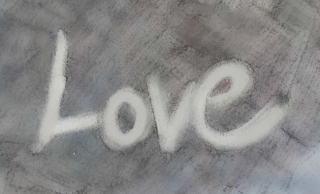 love painted, the word love hand-painted, artistic word love, white hand-made brush lettering on gray texture.の写真素材