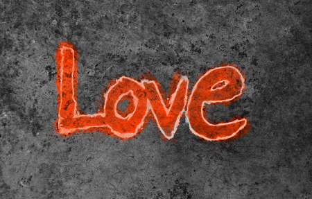 love painted, the word love hand-painted, artistic word love, rough painted outlined brush lettering on painted texture orange tint on gray grunge background.の写真素材