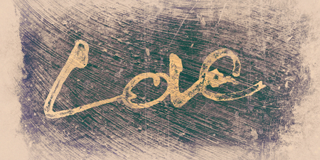 love painted, the word love hand-painted, artistic word love, brush lettering partially washed-out on wet paper with indian ink  on painted grunge texture background, with pale vignette. Yellow and purple tints.の写真素材