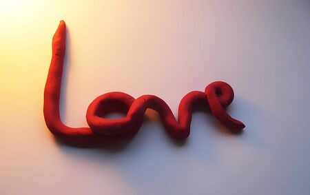 love clay, the word love hand-made in red modeling clay, love word in clay, 3D love word with...